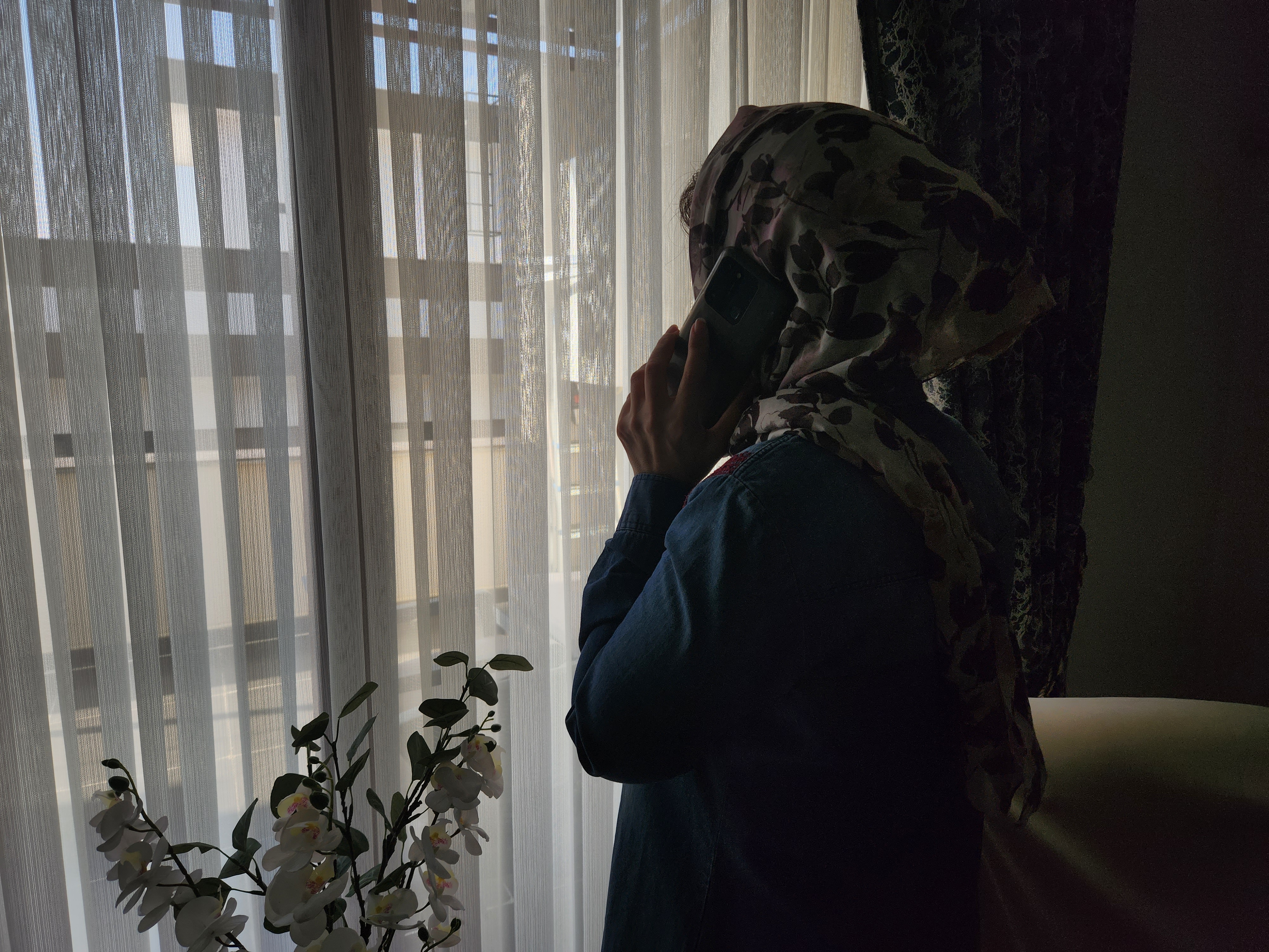 Iranian believer talking on her phone