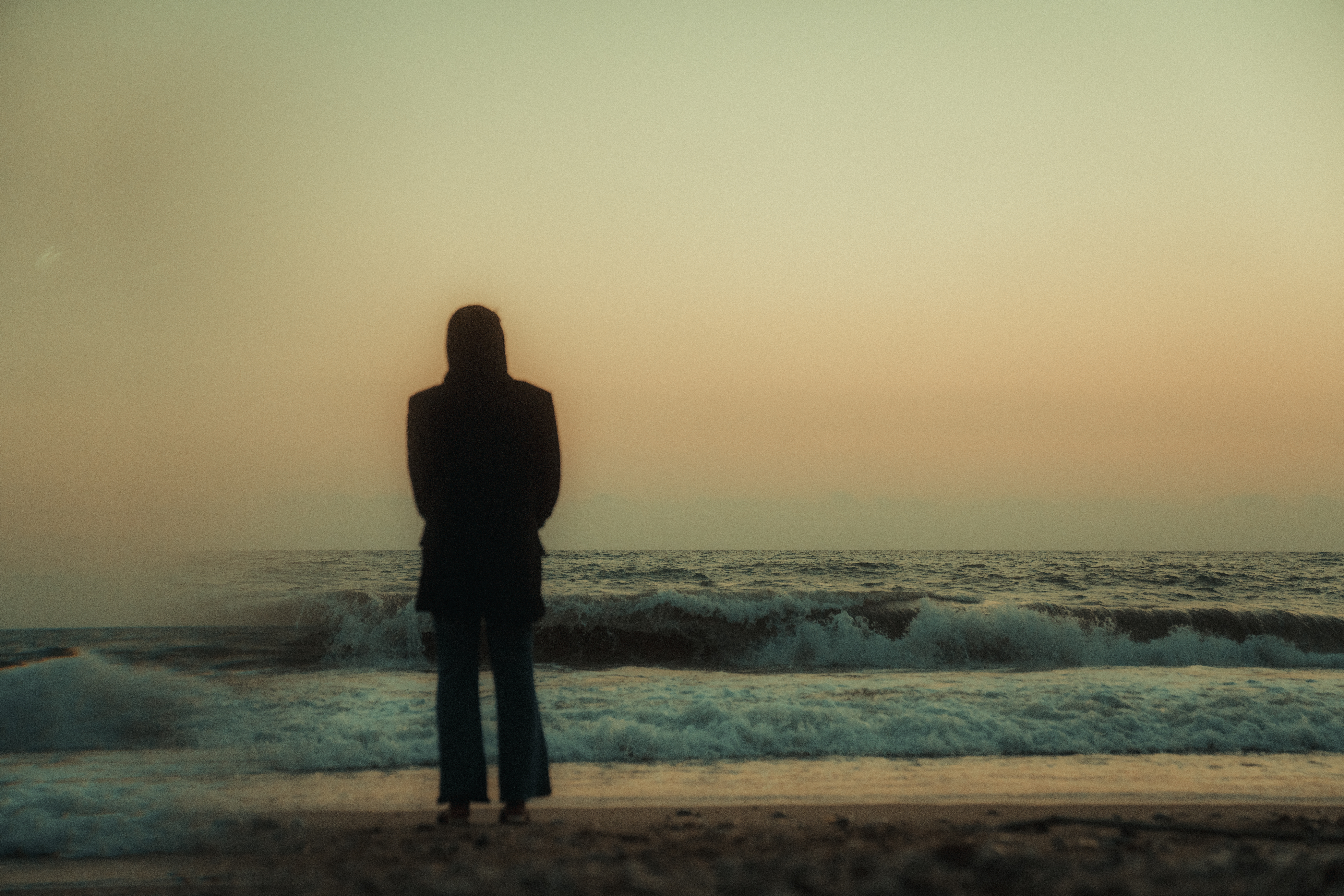 Yemeni believer standing on the beach at sunset