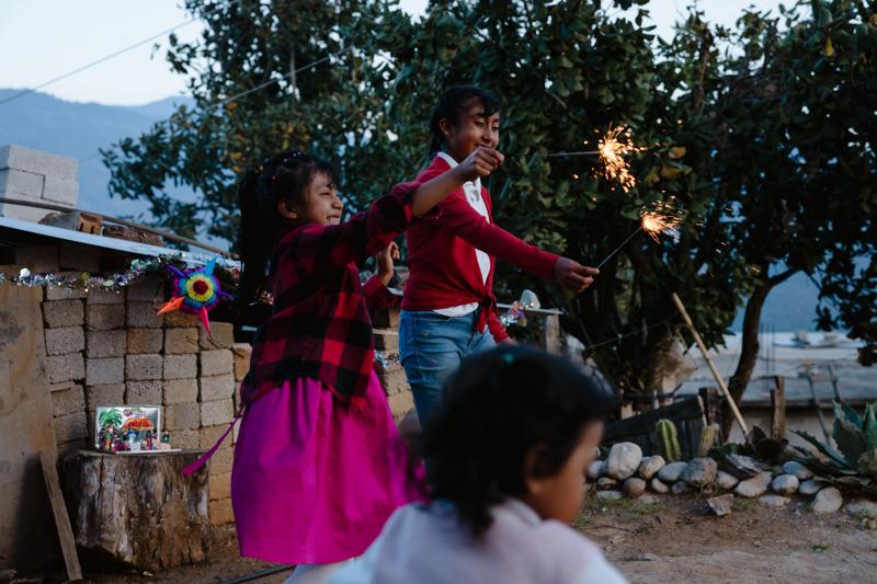 Alicia playing with other children and sparklers