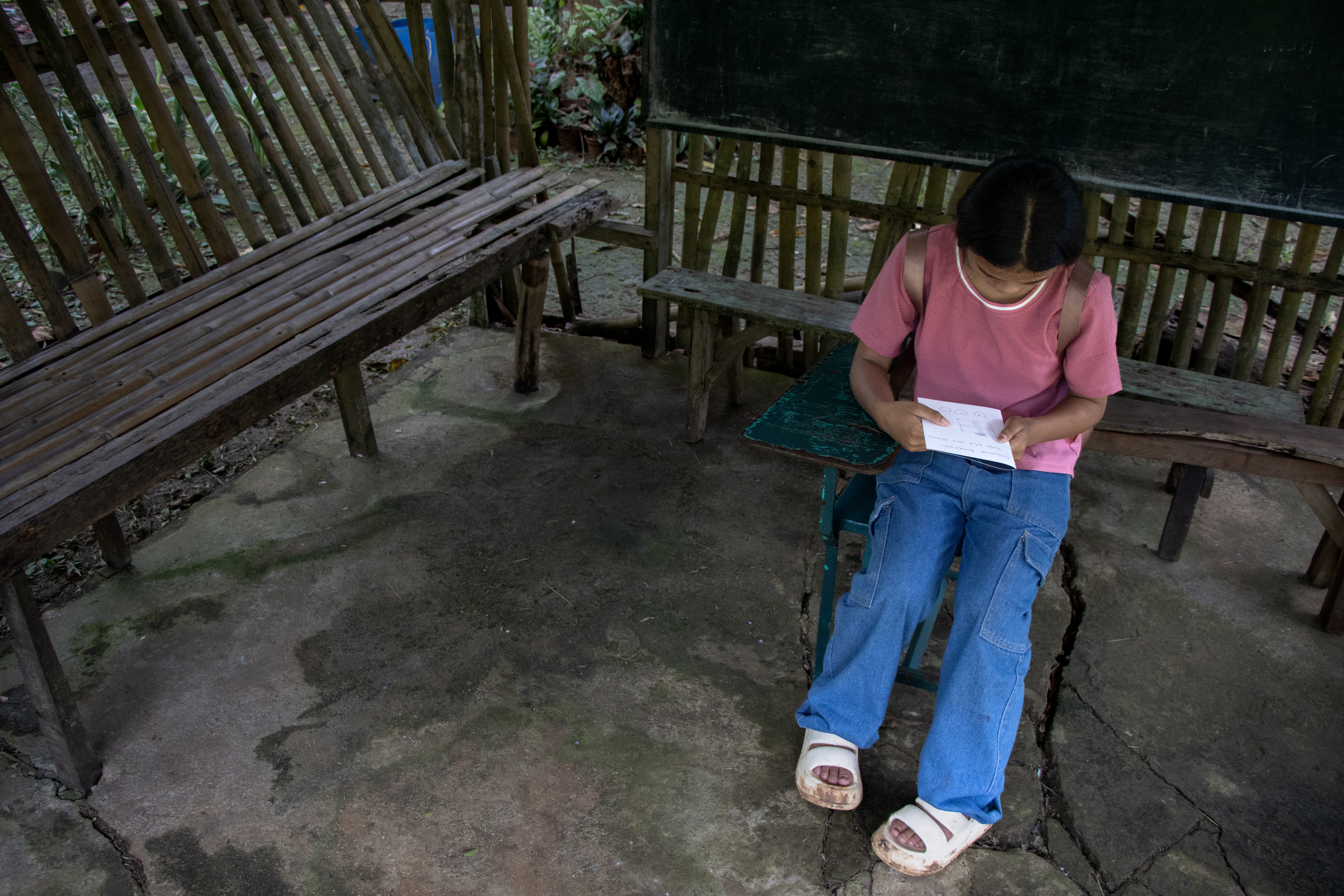 Dayang sits and writes a letter for Christmas