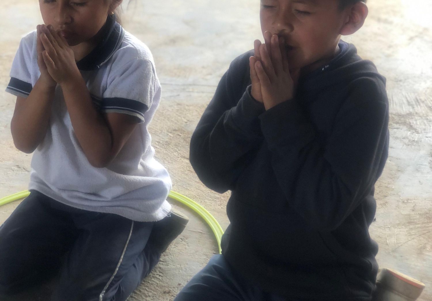 Children praying at school in Colombia