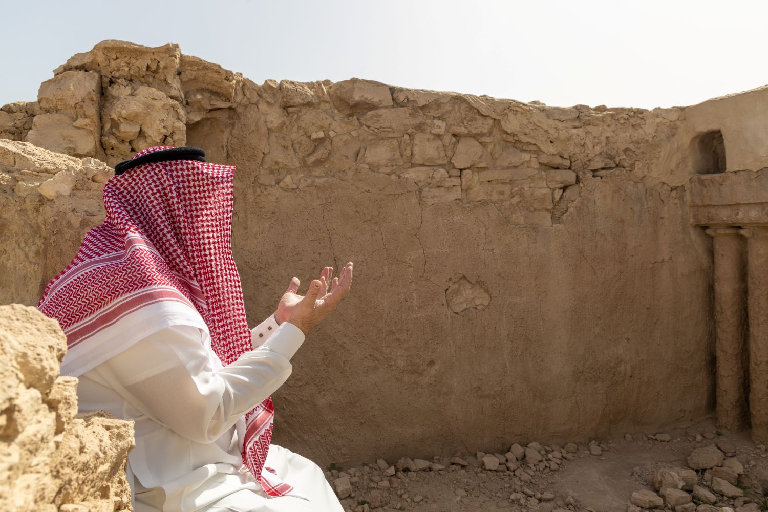 Church ruin with man wearing thobe and ghutra in Saudi Arabia