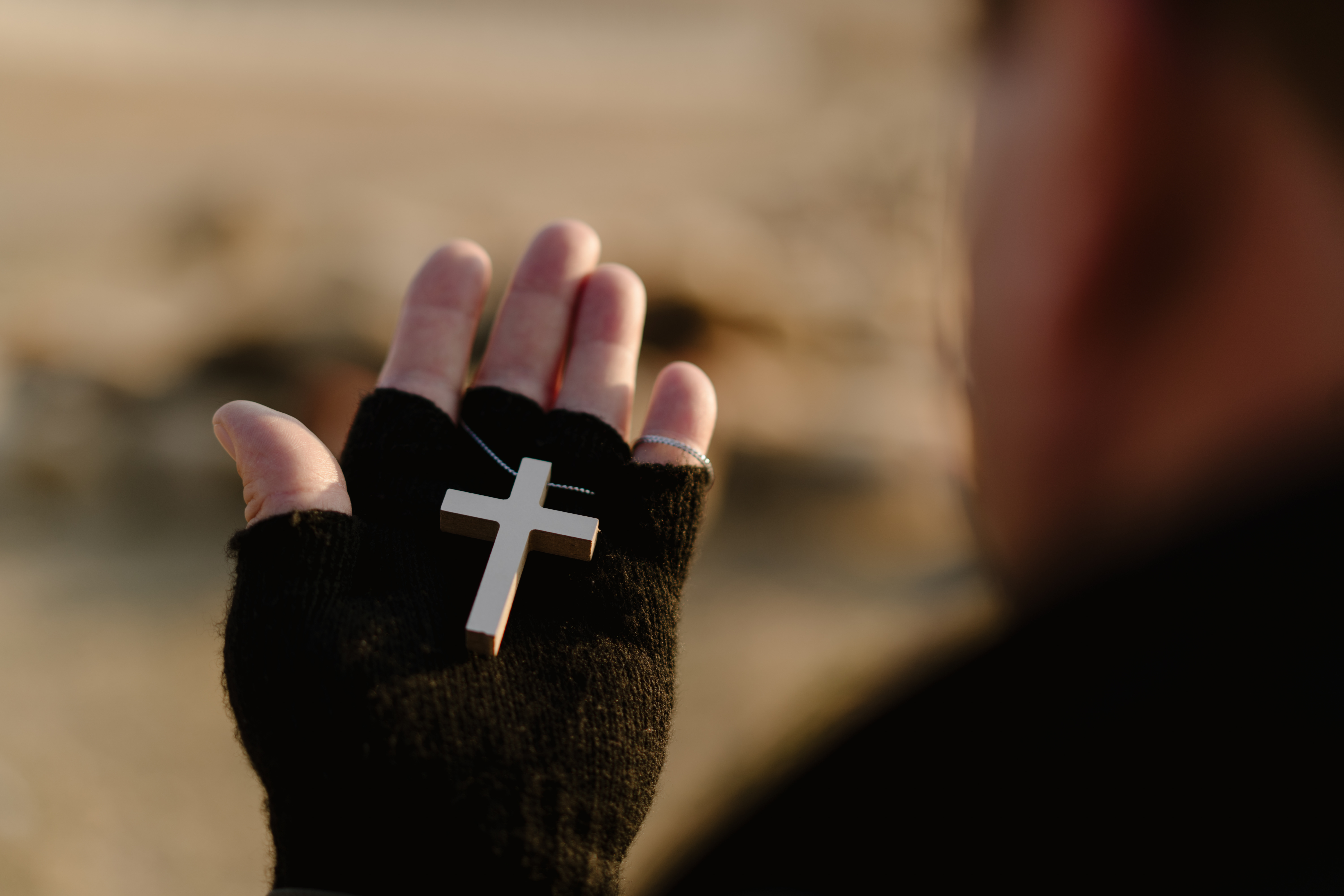 Yasin holding a cross necklace