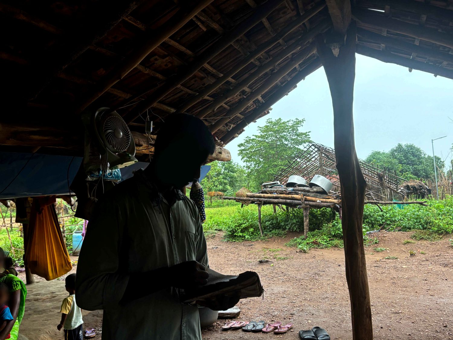 Pastor Sampath reading a verse from the Bible in India