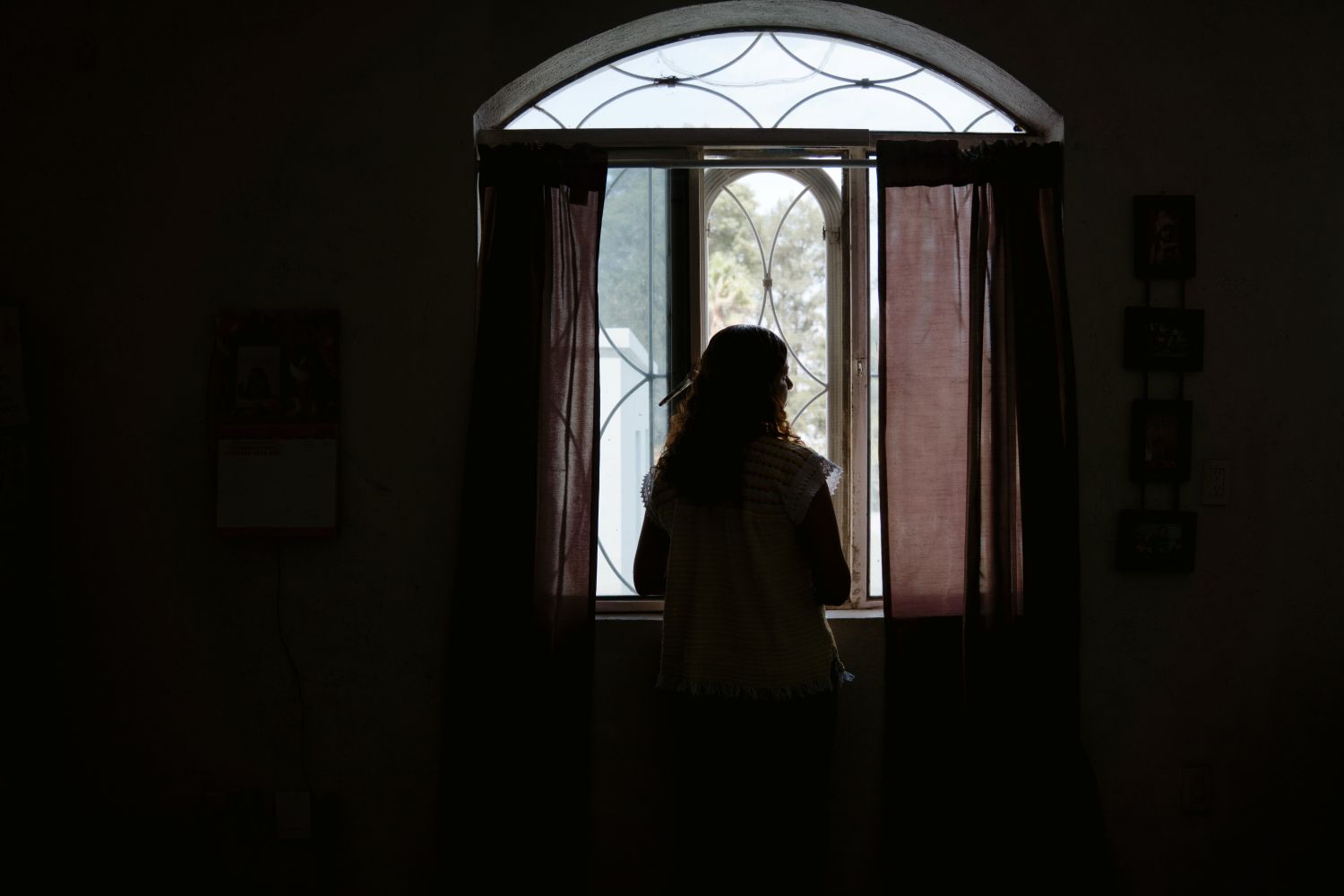 Silhouette of Beatriz looking out the window in Mexico