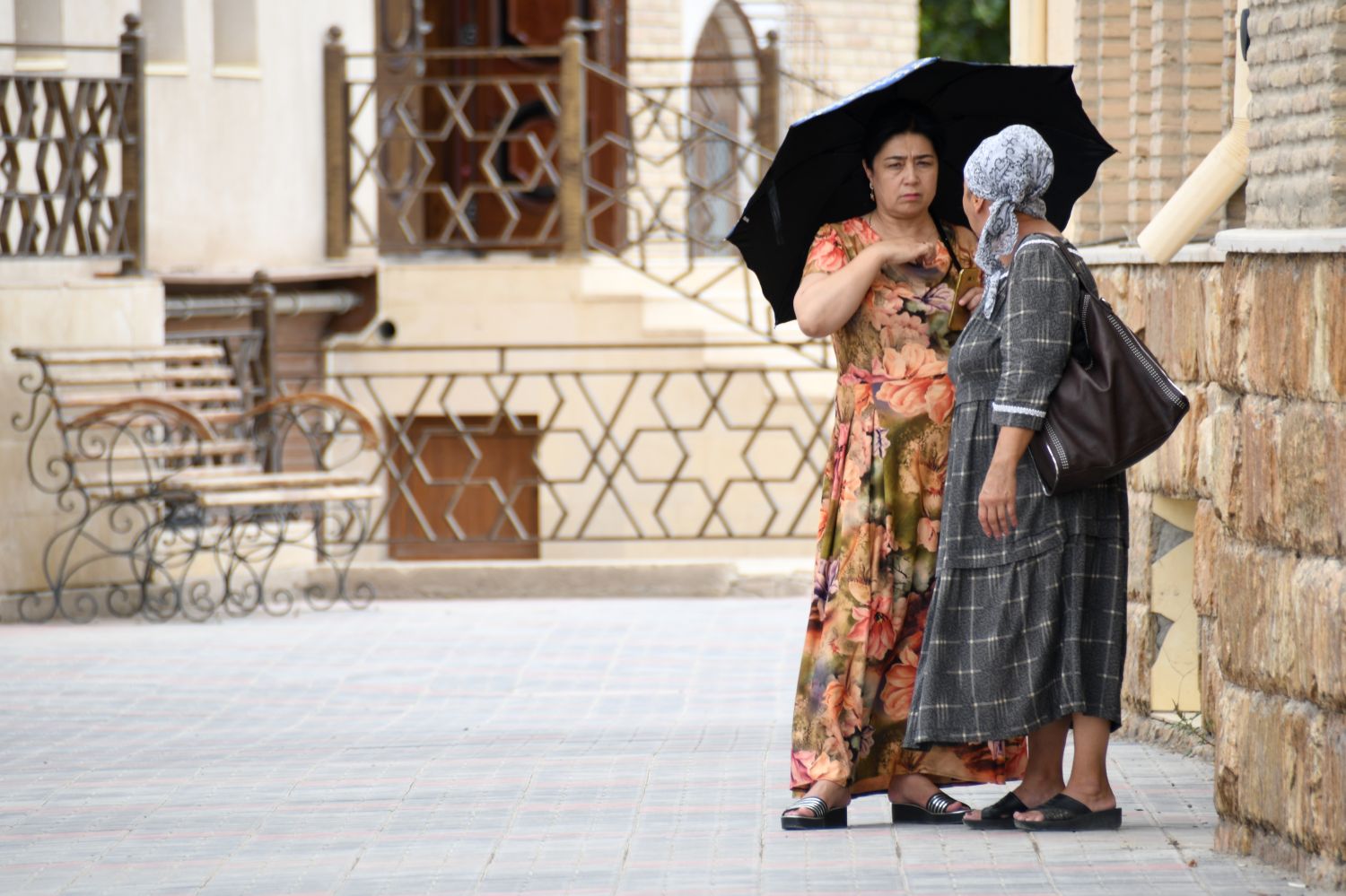 Two women with an umbrella in Uzbekistan